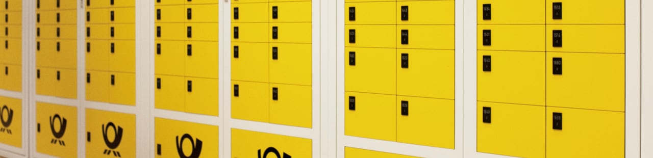 Eine Wand mit gelben Postfächern der Deutschen Post.